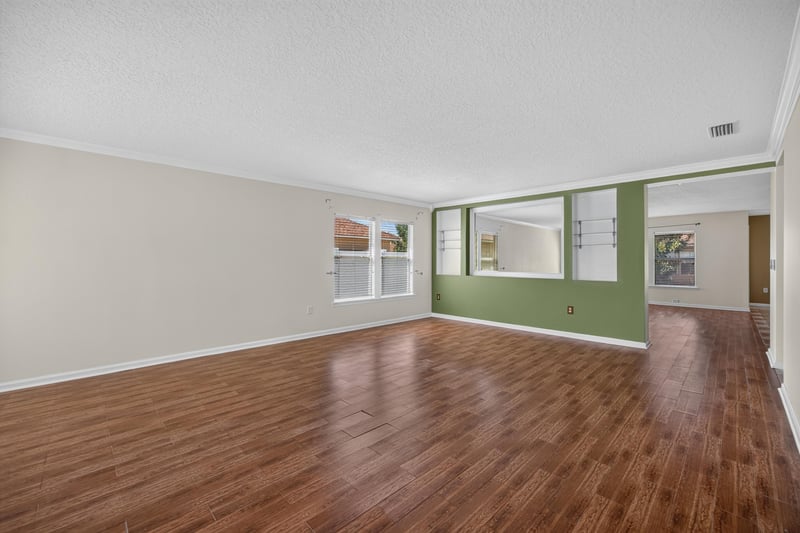 Empty living and dining area with multiple windows at 2282 Justin Lake Dr, Jacksonville, FL