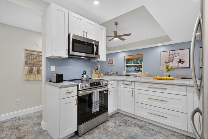 Kitchen with stainless range and white cabinets at 1525 8th St N, Jacksonville Beach, FL