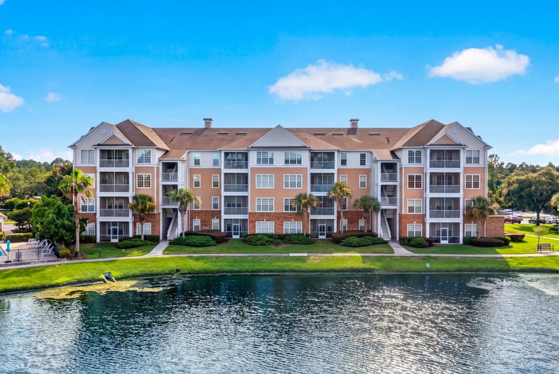 Aerial view of the condo building beside the lake in Campfield
