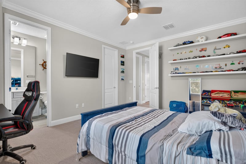 Bedroom with shelving and TV at 22 Azura Point