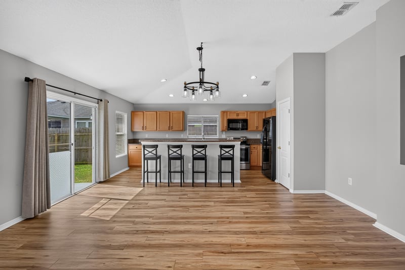 Kitchen island with bar stools at 7545 Lirope St, Jacksonville, FL 32244