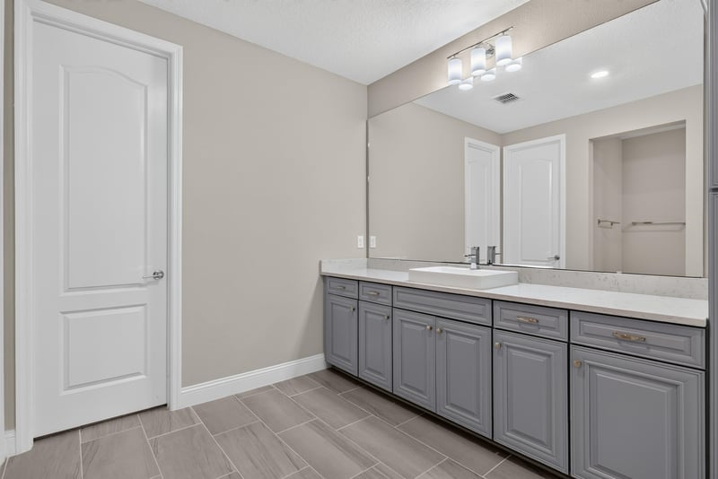 Primary bathroom vanity with mirror at 22 Azura Point