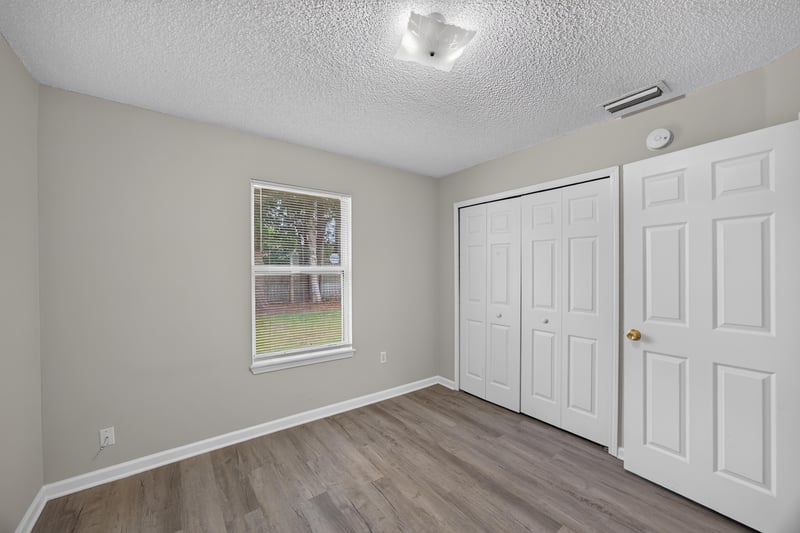 Bedroom with double closet doors at 8519 Blazing Star Ct, Jacksonville, FL 32210