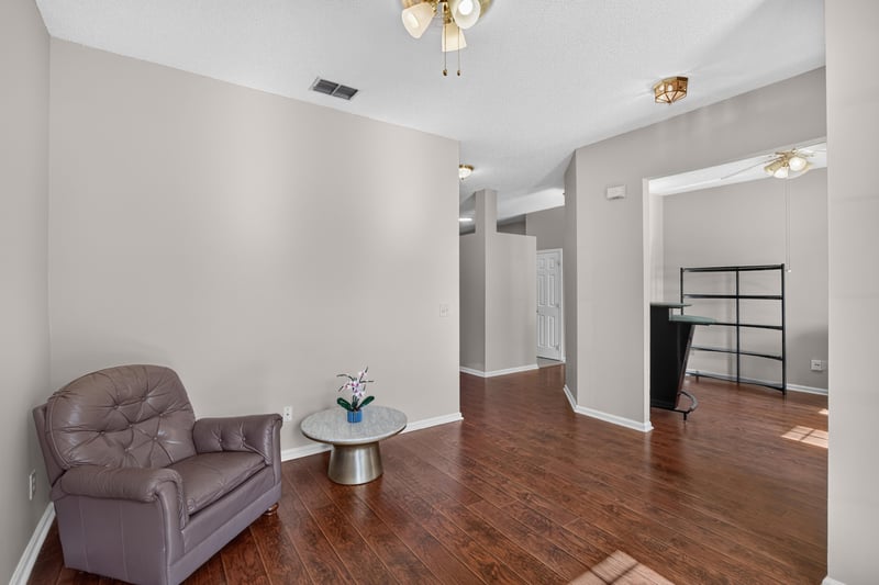 Living area with ceiling fan and wood floor at 11828 Heather Grove Ln, Jacksonville, FL