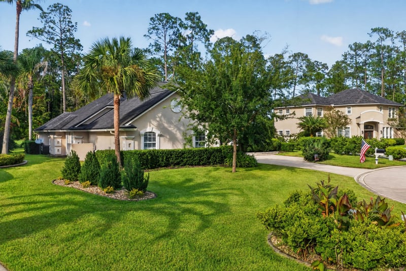 Front exterior with driveway and landscaped lawn at 2304 Spring Hill Ct, Orange Park, FL