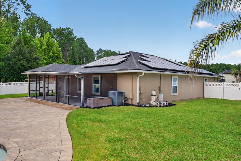 Rear exterior with solar panels at 706 Grampian Highlands Dr, St. Johns, FL 32259