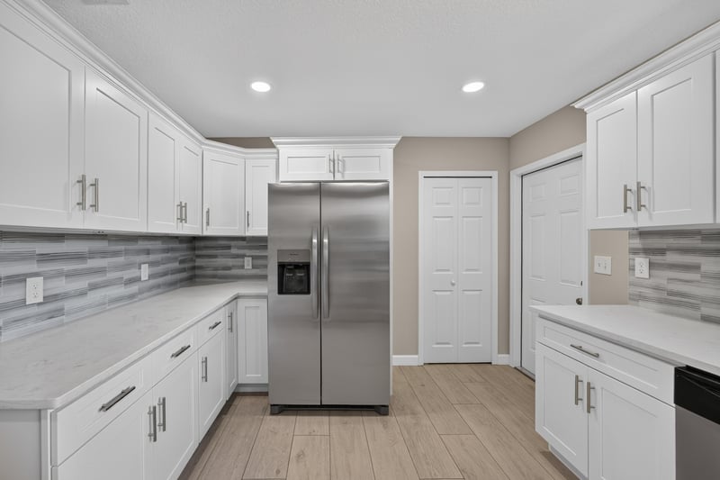 Kitchen refrigerator and white cabinetry at 4117 Wilcrest Ct, Jacksonville, FL 32277