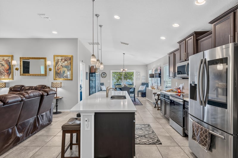 Kitchen with stainless refrigerator and island at 589 Seville Pkwy, St. Augustine, FL