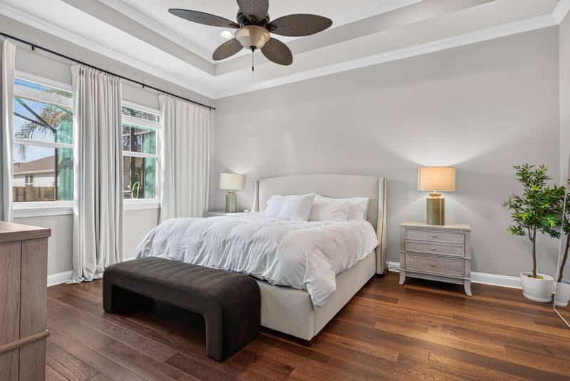 Primary bedroom with tray ceiling and bench at 3328 Southern Oaks Dr, Green Cove Springs, FL 32043