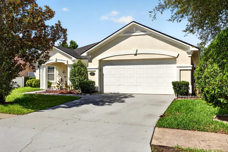 Front exterior with driveway and two-car garage at 2282 Justin Lake Dr, Jacksonville, FL