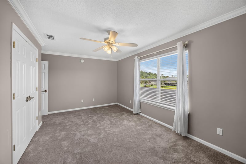 Bedroom with carpet and curtained window at 1493 Greyfield Dr, St. Augustine, FL 32092