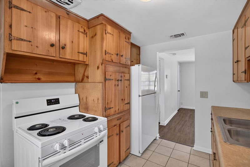 Kitchen with range and hallway view at 5812 Tampico Rd, Jacksonville, FL 32244