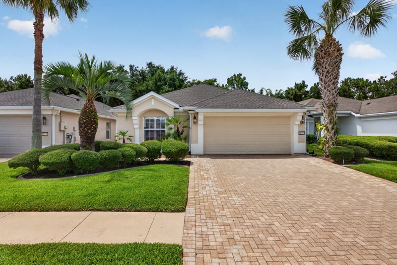 Front exterior with paver driveway and landscaping at 11225 Water Spring Cir, Jacksonville, FL 32256