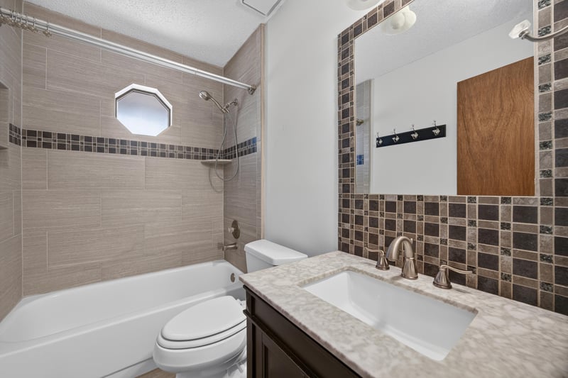 Bathroom with tub-shower combo and tile surround at 2460 San Sago Ln, Jacksonville, FL