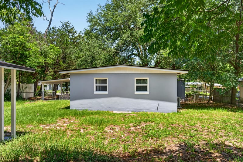 Backyard view with covered carport at 1928 Montmarte Dr, Jacksonville, FL 32210