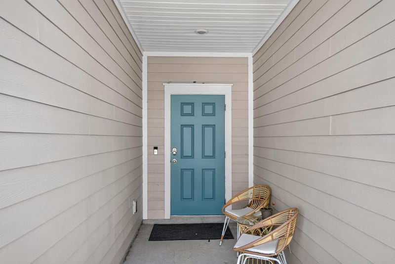Covered front entry with teal door at 1186 Beach Dune Dr, Jacksonville, FL 32233