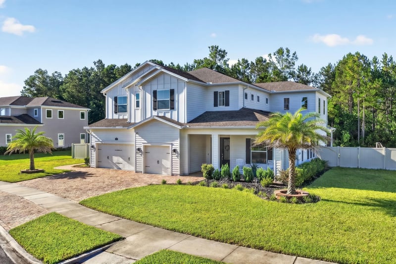 Front exterior with palm tree and driveway at 22 Azura Point