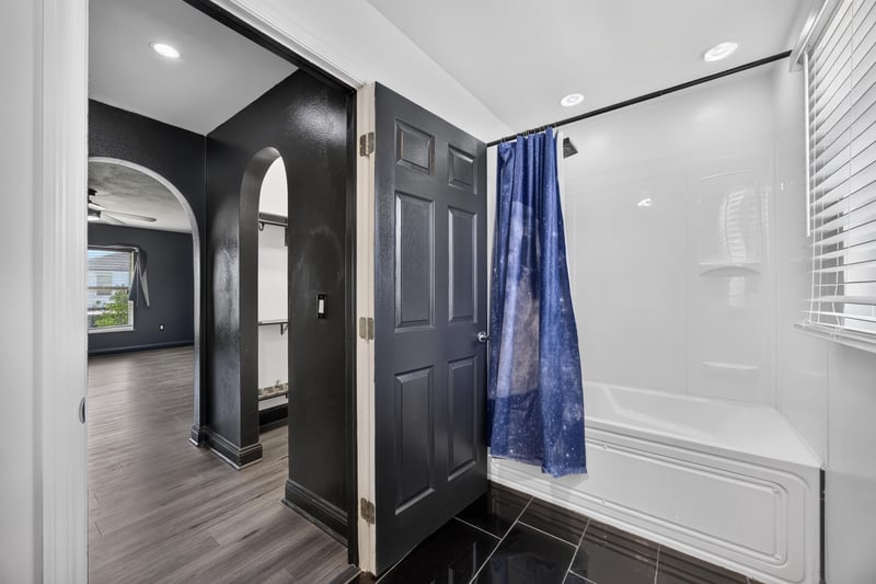 Bathroom with glass shower and dark door at 3428 Glenn Hollow Ct, Jacksonville, FL 32226