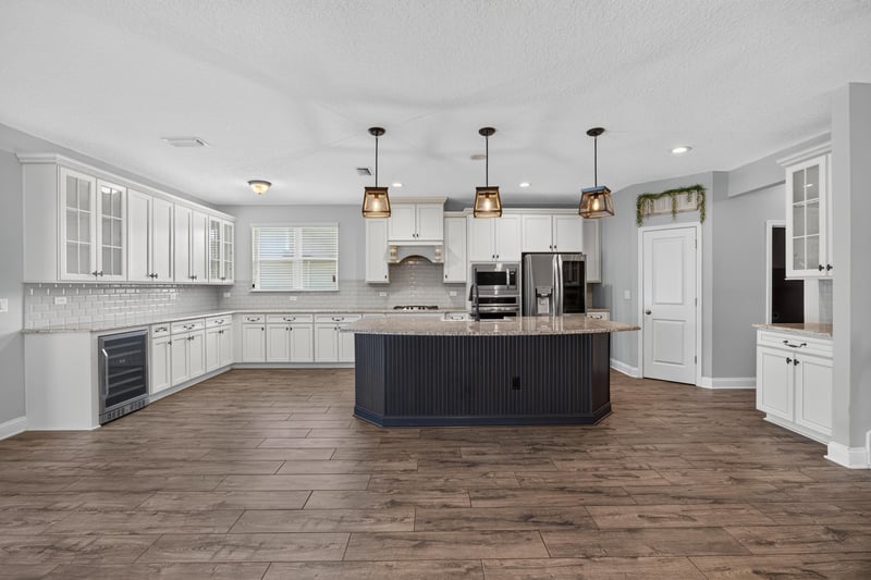 Kitchen with white cabinets, island and pendant lighting at 53 Lumen Ct, St. Augustine, FL 32095
