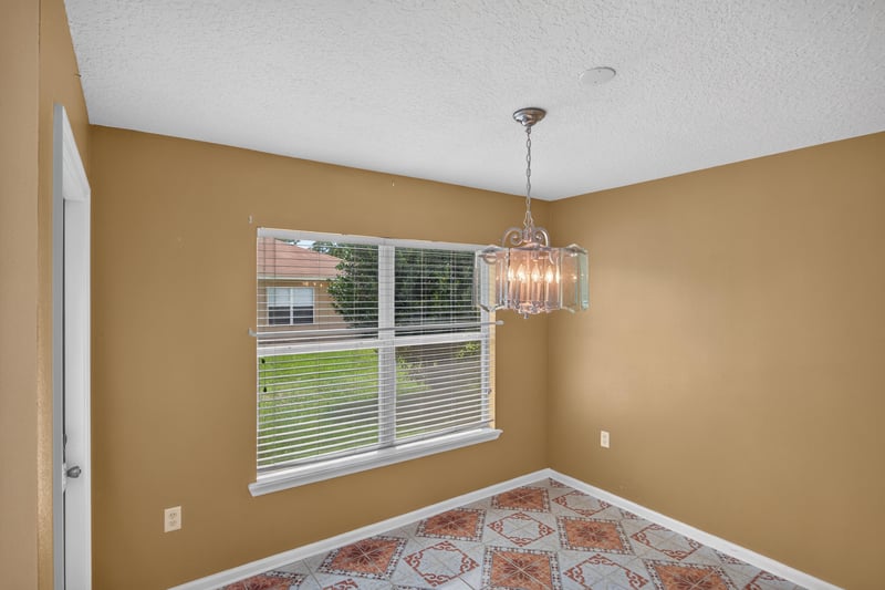 Empty breakfast nook with chandelier and window at 2282 Justin Lake Dr, Jacksonville, FL
