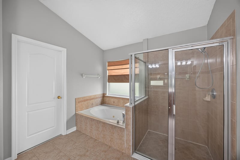 Bathroom with soaking tub and walk-in shower at 635 Wakeview Dr, Orange Park, FL 32065