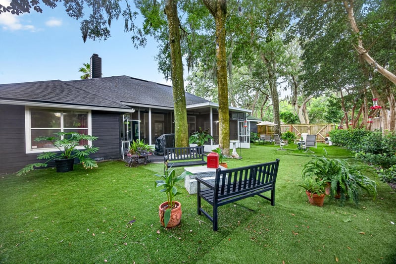 Backyard view toward the house and patio bench at 1346 Gately Ct, Jacksonville, FL 32225