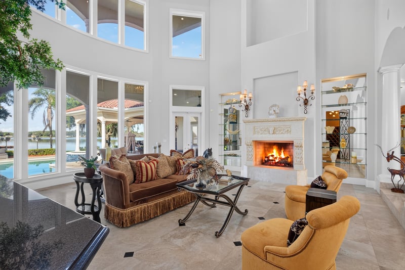 Great room with two-story windows, water view and fireplace at 344 Broward Rd, Jacksonville, FL
