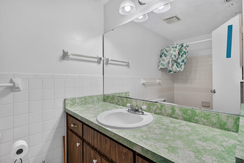 Bathroom vanity with green countertop at 9954 Larkdale Ct, Jacksonville, FL 32257