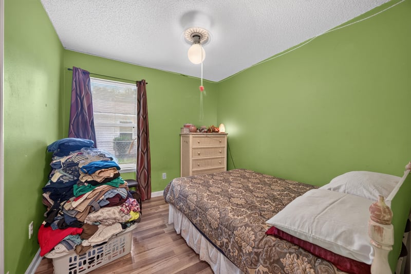 Bedroom with green walls and bedding at 5375 Dodge Rd, Jacksonville, FL 32209