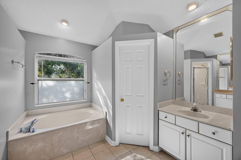 Primary bath with soaking tub and window at 470 Sparrow Branch Cir, Jacksonville, FL 32259