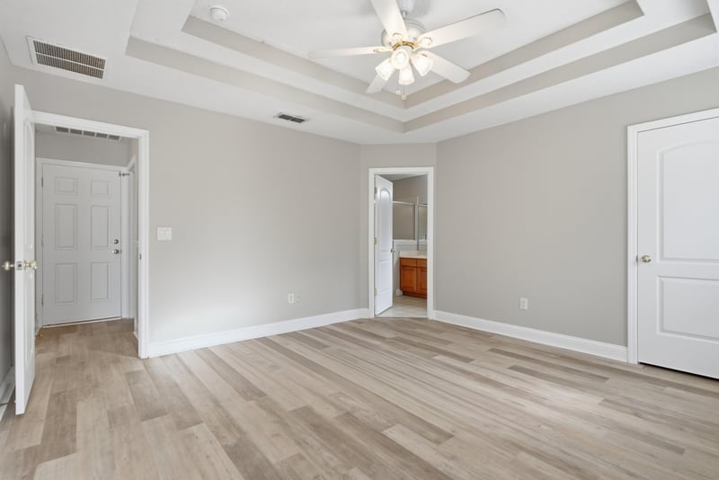 Bedroom with tray ceiling and two entry doors at 14187 Big Spring St, Jacksonville, FL 32258