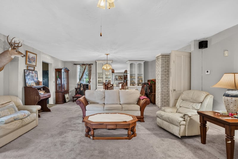 Living room with cream sofas and taxidermy decor at 1173 US-17, Satsuma, FL 32189