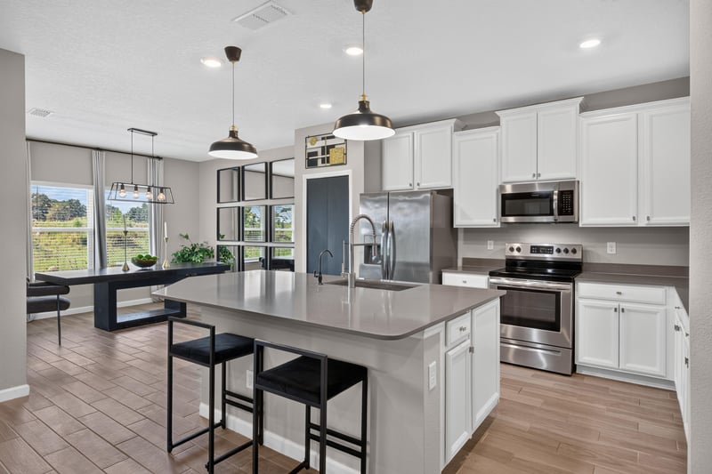 Kitchen with island, stainless appliances and pendant lights at 9942 Lovage Ln, Jacksonville, FL 32219