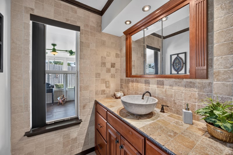 Bathroom vanity with mirror at 6931 Cane Grass Ln E, Jacksonville, FL 32244