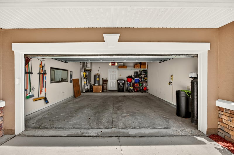 Garage with stored items and overhead shelving at 3660 Middlebrook Dr, Orange Park, FL 32065