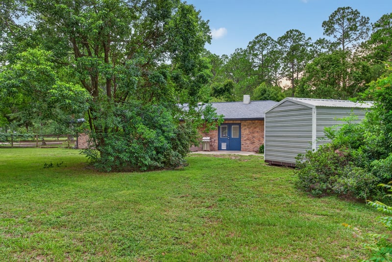 Side yard with storage shed and trees at 3249 Maryland Ave, Green Cove Springs, FL