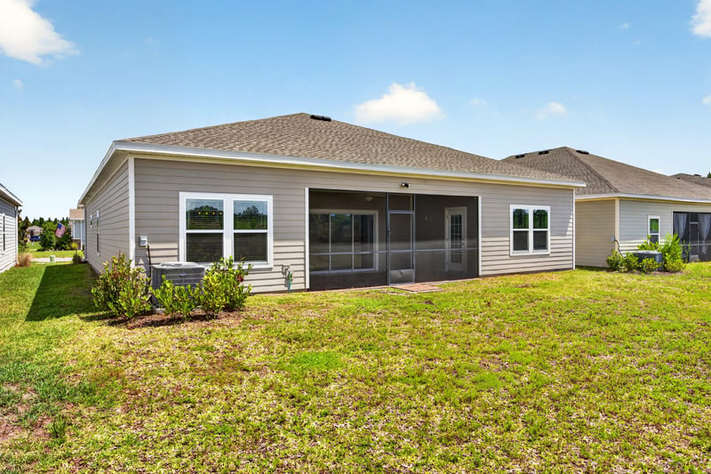 Rear exterior view of home and yard at 9942 Lovage Ln, Jacksonville, FL 32219