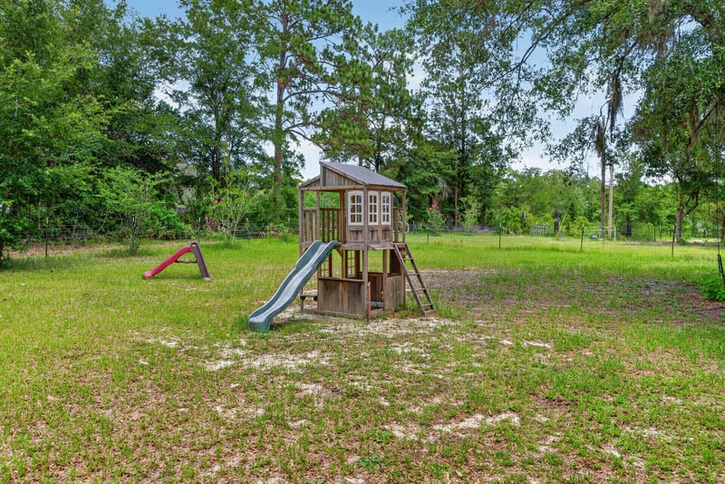 Backyard playground with slide and swing set at 4890 McAllister Rd, Middleburg, FL 32068