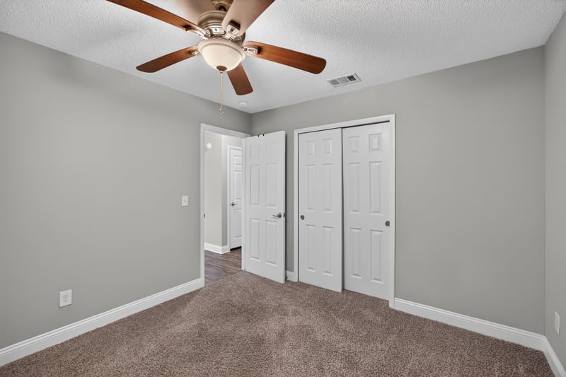 Carpeted bedroom with closets and hallway view at 12344 Cormorant Ct, Jacksonville, FL