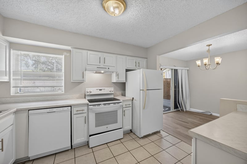Kitchen with white appliances and tile flooring at 2658 Trollie Ln apt 1, Jacksonville, FL 32211