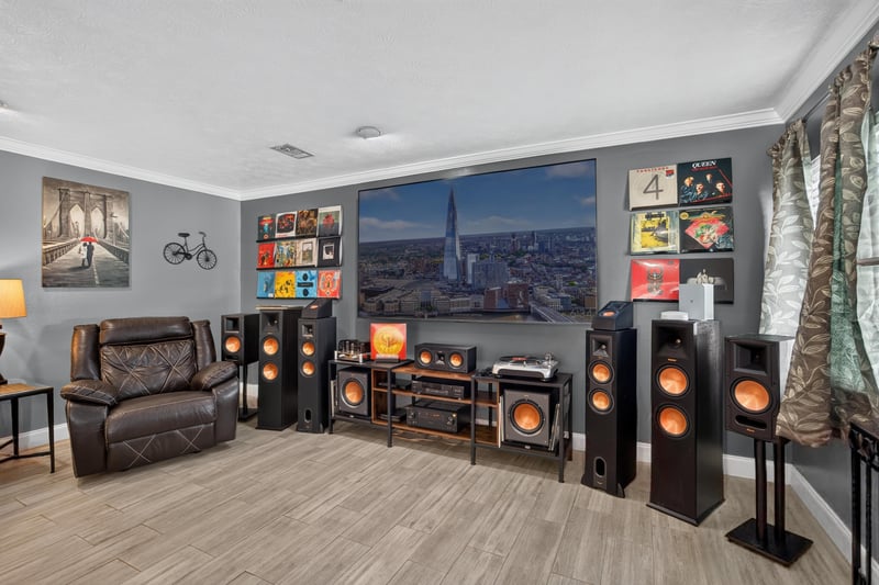 Living room with media speakers and wall art at 6059 Karen St, Jacksonville, FL 32244