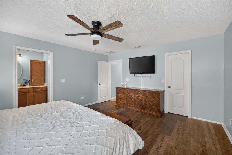 Bedroom with wall-mounted tv at 1589 Backwater Drive, Middleburg, FL 32068