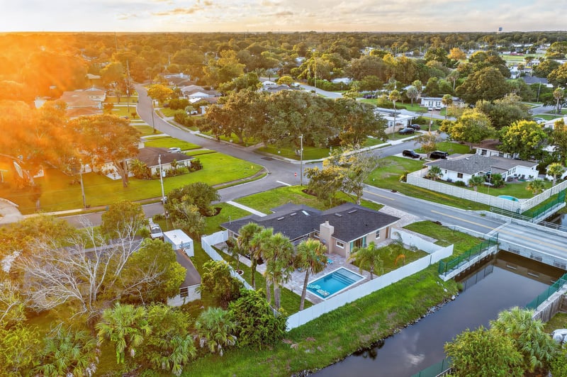 Aerial day-to-dusk view of the home and surrounding neighborhood at 1525 8th St N, Jacksonville Beach, FL