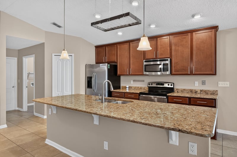 Kitchen island with granite counters at 469 Glendale Ln, Orange Park, FL