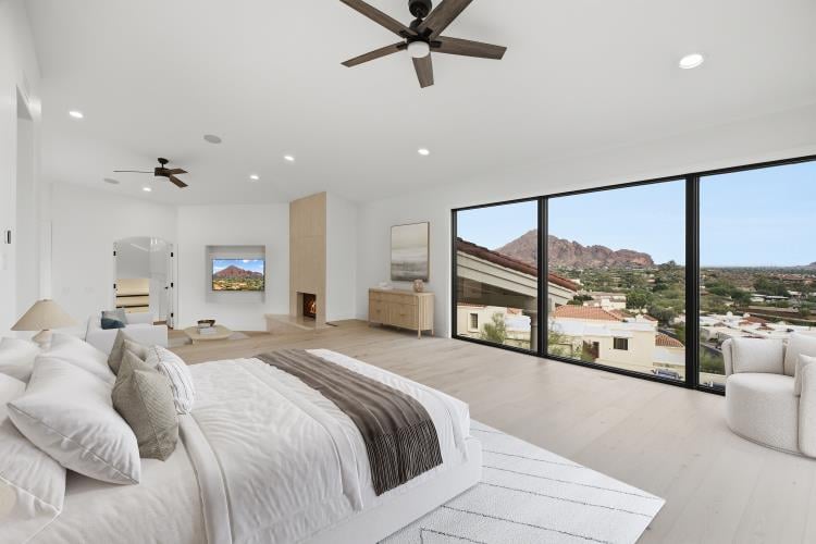 Primary bedroom with Camelback Mountain through the windows, virtually staged