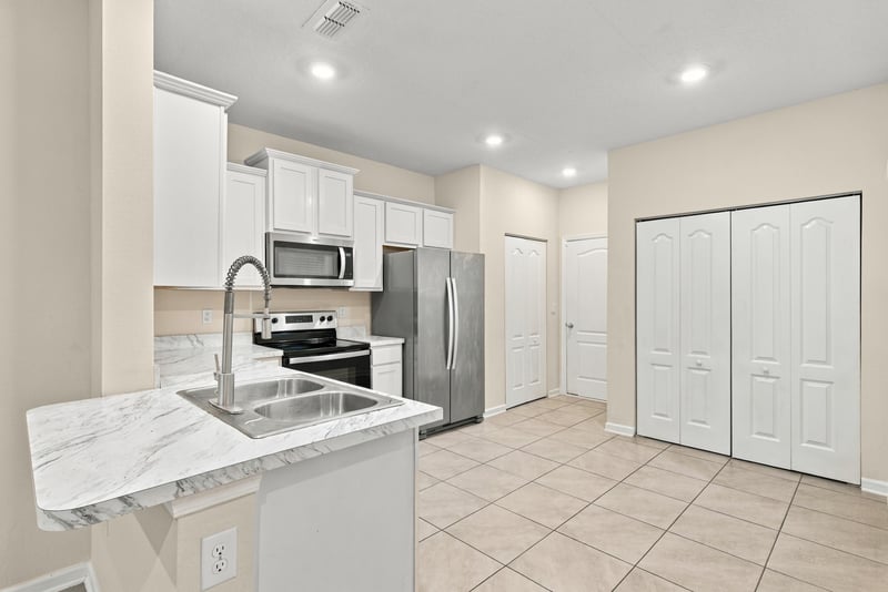 Kitchen island view with stainless refrigerator and range at 9555 Star Dr, Jacksonville, FL 32256