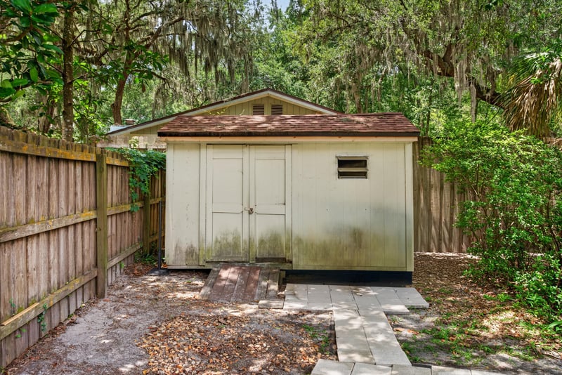 Backyard storage shed in fenced yard at 12810 Swamp Owl Ln
