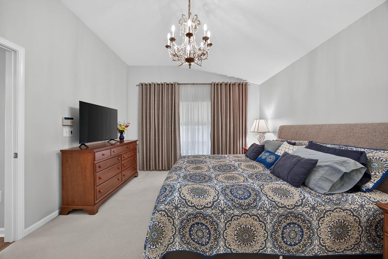 Primary bedroom with television and dresser at 11225 Water Spring Cir, Jacksonville, FL 32256