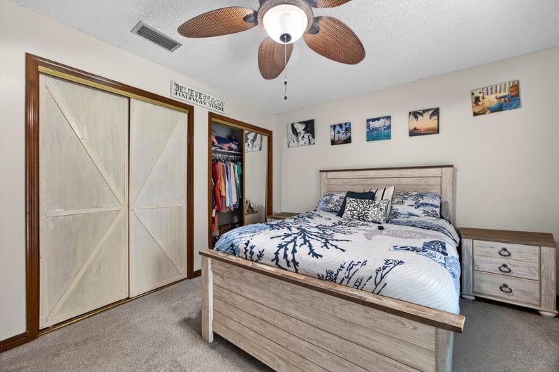 Bedroom with sliding closet doors and bed at 981 Marble Ridge Dr, Orange Park, FL 32065