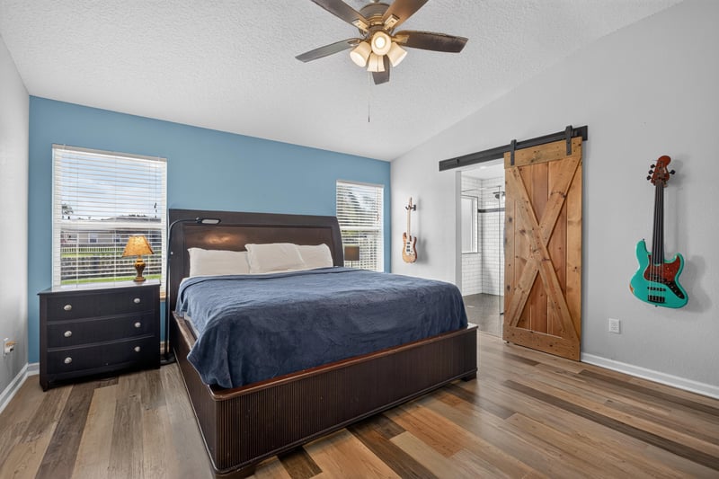Primary bedroom with barn door and dresser at 2065 Creekmont Dr